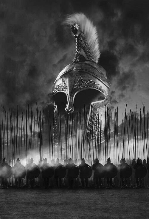 a black and white photo of a helmet with feathers on it, surrounded by spears