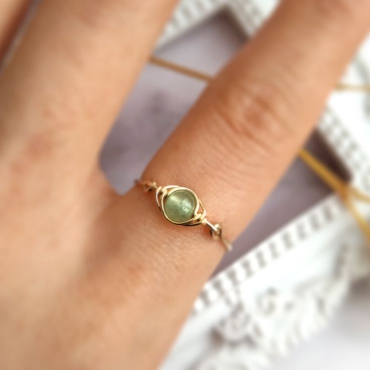 This cute handmade wire wrapped ring is made with genuine and natural Jade gemstone in a light green color. The metal part is 14k gold filled or sterling silver of your choice. ✨ Simple & cute ring in a clean and minimalist design. Jade Gemstone Meaning:💚 Abundance, Luck, Protection; Jade is a wonderful stone that is used to bring good luck, wealth, and energy protection to the wearer. In Chinese culture, it is a symbol of prosperity, wellness & harmony. • Gemstone Diameter: 4 mm• Ring Band: 0.