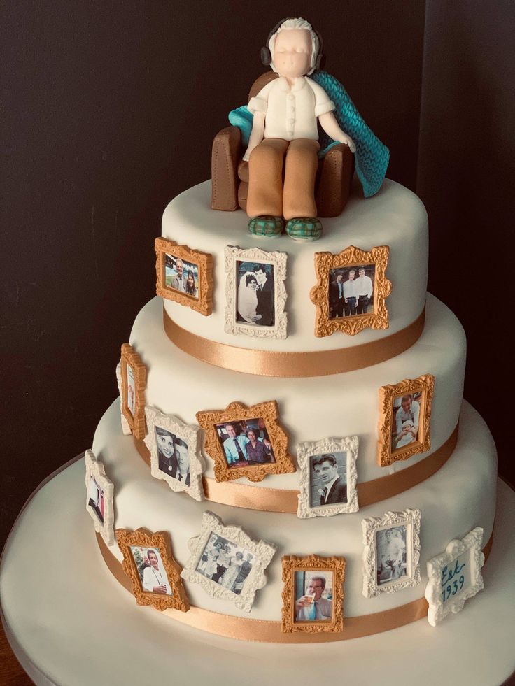 a three tiered cake with pictures on the side and an elderly man sitting on top