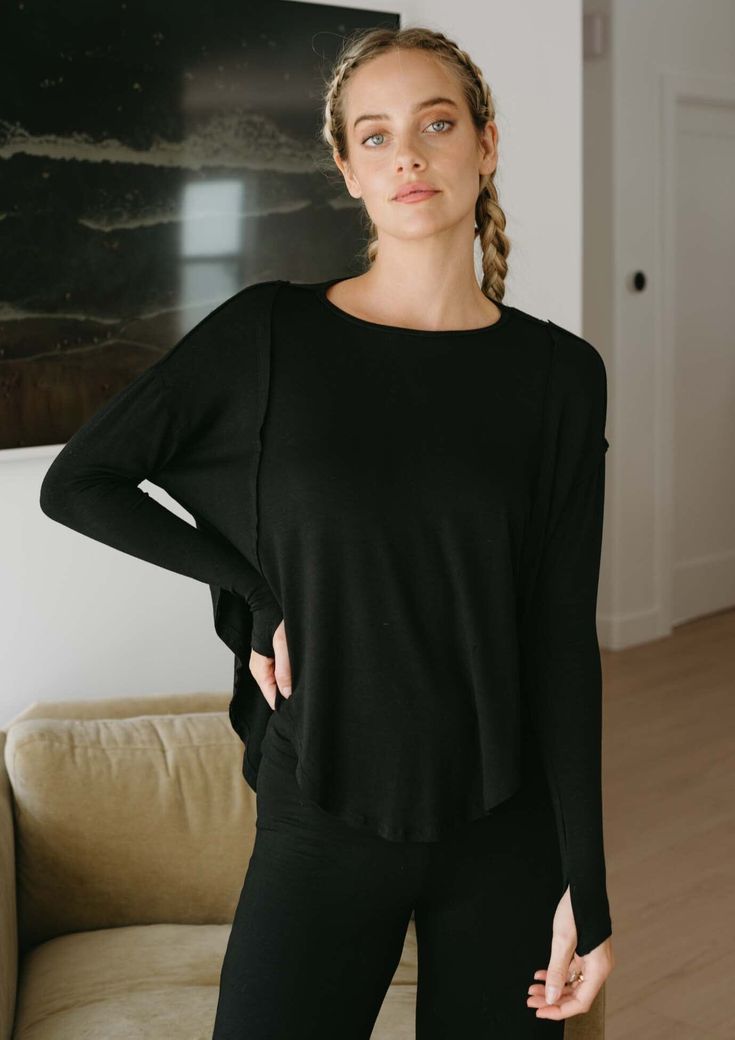 This ultra-cozy long sleeve features fitted sleeves, raw edges, and a flowy, oversized body that makes for the perfect post workout piece. FitThis style runs true to size. 23" front 27" back measuring from a small. Size range = XS 0-2, S 2-4, M 6-8, L 10-12, XL 12-14. FabricMoisture wicking, ultra soft active jersey. 95% Rayon, 5% Spandex. Jala is ethically made with love in Southern California, USA. CareFor best care, wash with cold water on gentle cycle. Tumble dry with low heat, lay flat or l Black Long Sleeve Top With Thumbholes For Layering, Black Long Sleeve Top With Thumbholes For Fall, Black Long Sleeve Crew Neck Top With Thumbholes, Everyday Athleisure Tops With Thumbholes, Long Sleeve Athleisure Tops For Everyday, Black Long Sleeve Tops With Thumbholes, Relaxed Fit Tops For Yoga In Fall, Fall Yoga Tops With Relaxed Fit, Relaxed Fit Yoga Tops For Fall