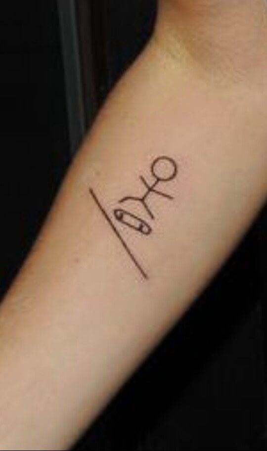 a person with a tattoo on their arm that says love and scissors in cursive writing