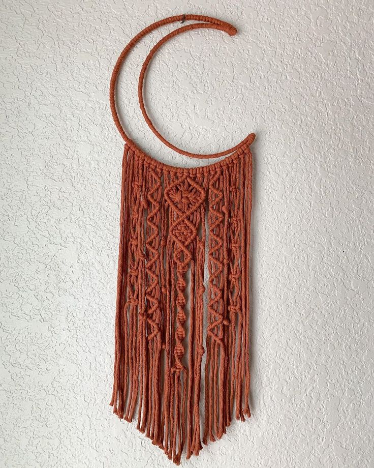 an orange necklace is hanging on the wall