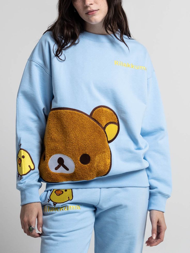 Long sleeve, ribbed crew neck sweatshirt Embroidered logo on the front Embroidered chenille patch with satin stitching Embroidered Kiiroitori on the sleeve 100% cotton Imported Officially licensed Rilakkuma merchandise The male model is wearing a large sweatshirt.The female model is wearing a small sweatshirt. Sweat Sets, Chenille Patch, Sweat Set, Little Outfits, Little Twin Stars, Rilakkuma, Satin Stitch, Female Model, Male Model