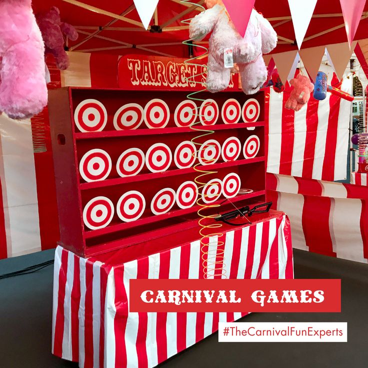 carnival games are on display under red and white striped tents