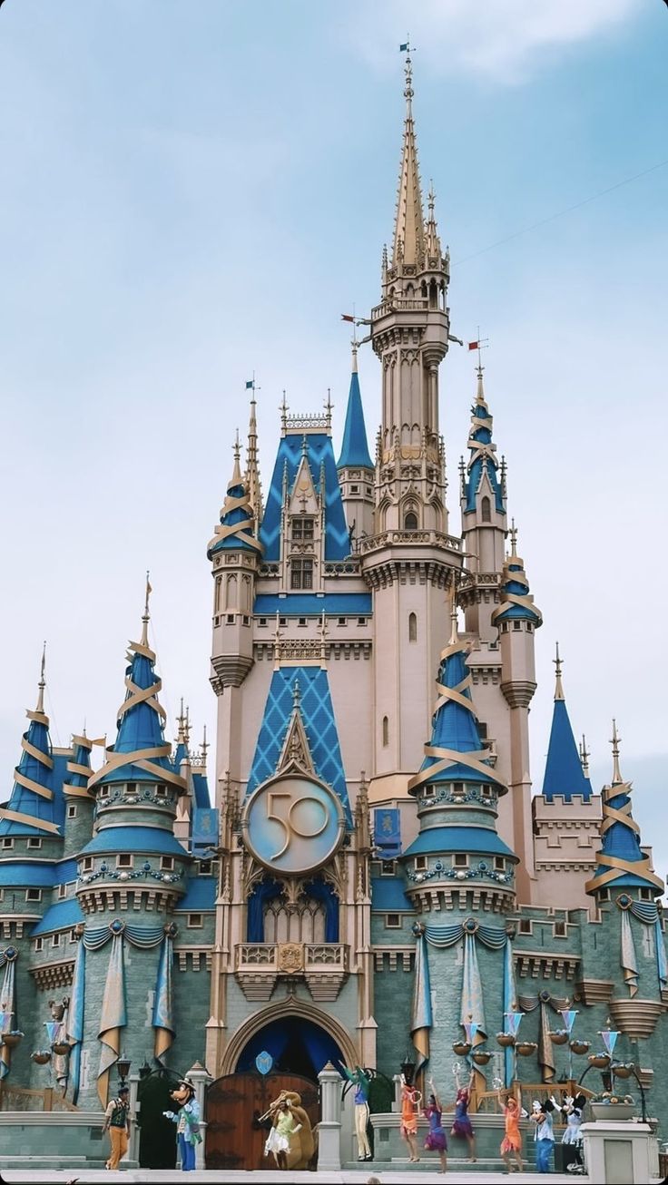 the castle has blue and gold decorations on it's front side, as well as a clock