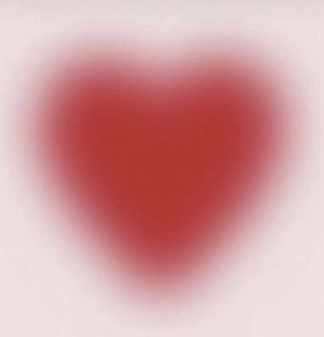 a red heart shaped object is shown in the middle of a white background with an overexposed image