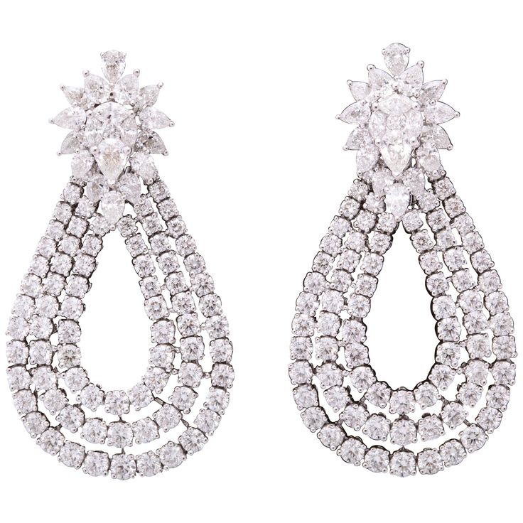 These earrings are a WOW!! Three rows of round diamonds set in a tear drop shape suspended from a fabulous cluster top. 15.60 carats of round, pear and marquise cut diamonds set in 18k white gold. Approximately 2 inches in length, approximately 1.20 inches at its widest point. A unique earring to add to any collection! Expensive Earrings, Unique Earring, Vintage Drop Earrings, Round Diamond Setting, Marquise Cut Diamond, Expensive Jewelry, Antique Earrings, Diamond Drops, Diamond Drop Earrings