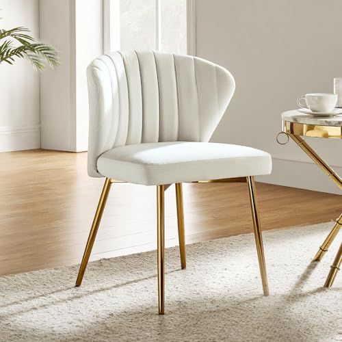 a white chair sitting next to a table on top of a rug