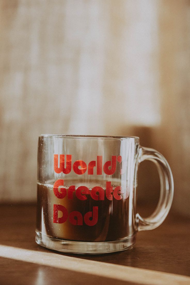 a coffee mug with the words world's greatest dad on it sitting on a table