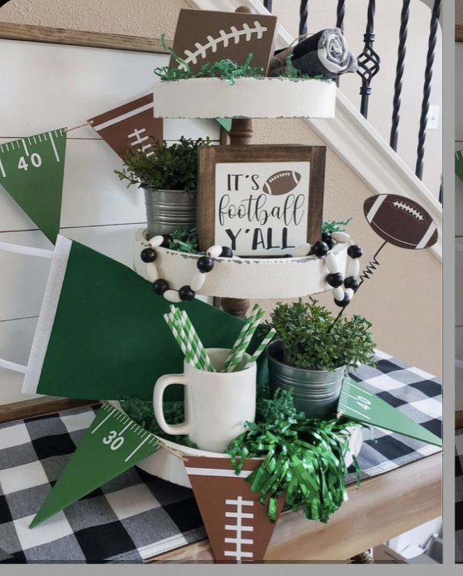 a football themed party with green and white decorations on the staircase rail, potted plants in front of a football sign