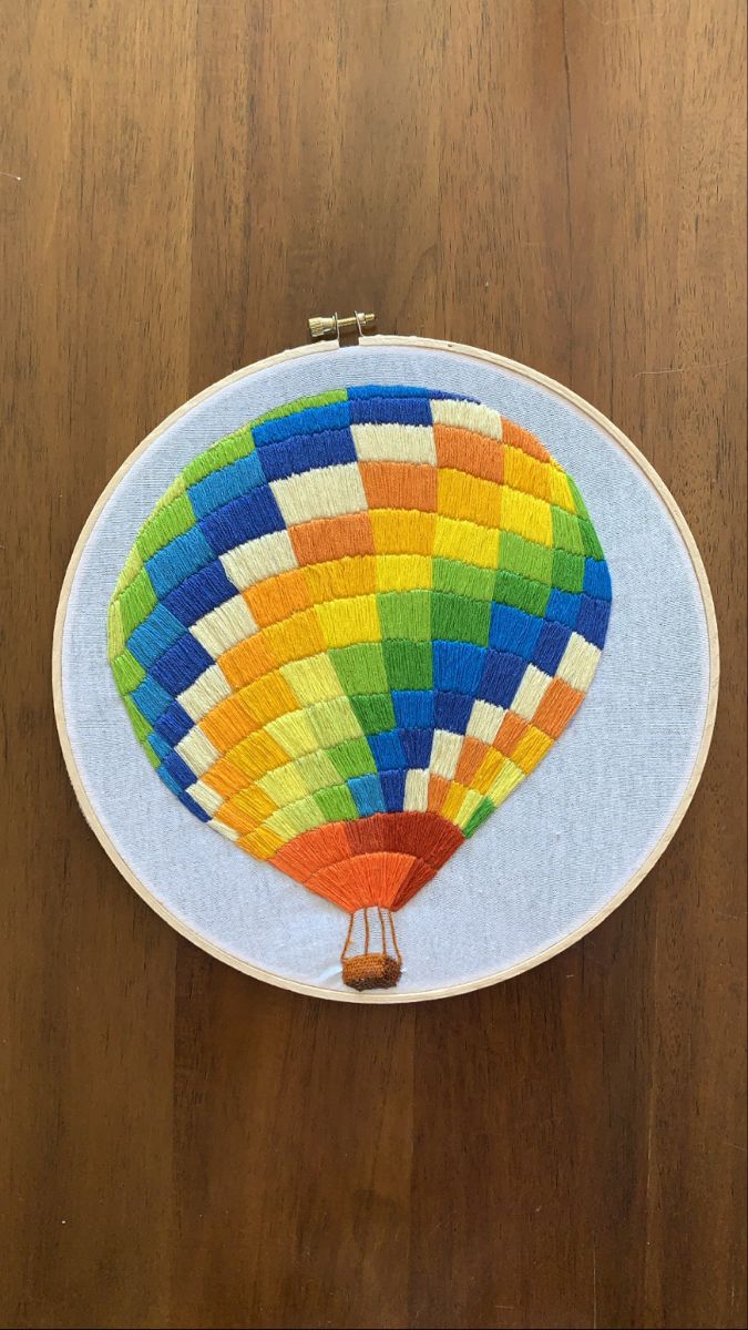 a multicolored hot air balloon on a wooden table