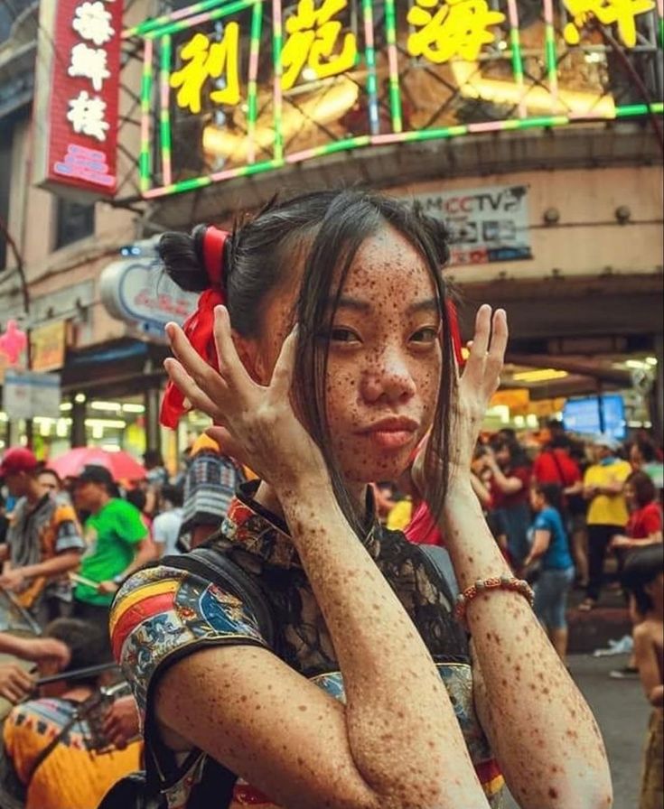 a woman is covered in mud and holding her hands up to her face as she walks down the street