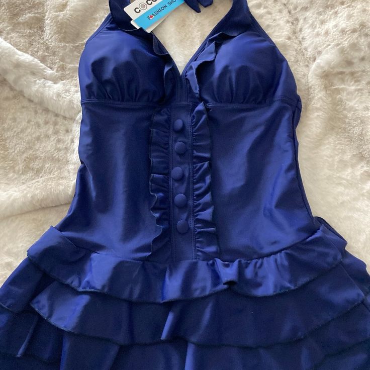 Nwt Navy Coco Pear Size S Ruffled Accents & Skirt Blue Ruffled Stretch Tankini, Blue Stretch Ruffled Tankini, Elegant Blue One-piece Tankini, Fitted Summer Tankini With Ruffles, Elegant Blue Sleeveless Tankini, Blue Fitted Ruffle Tankini, Fitted Ruffled Halter Neck Swimwear, Spring Party Tankini With Ruffles, Solid Fitted Dress For Pool