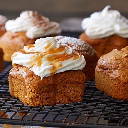 cupcakes with frosting and caramel on top sitting on a cooling rack