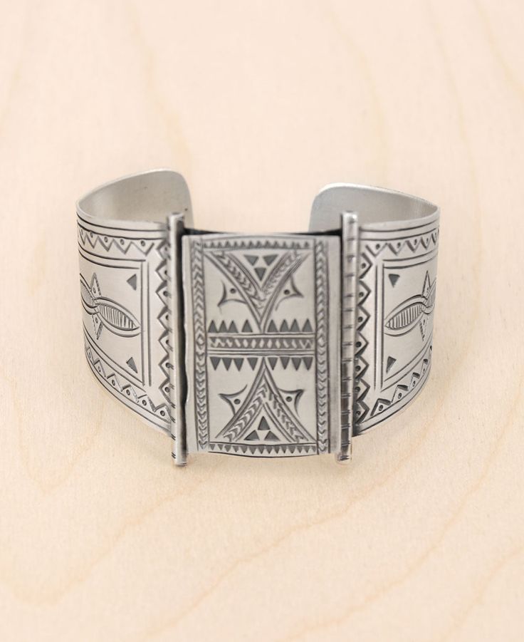 Evoke an aura of mystery and allure with our Hilltribe Silver Wide Cuff Bracelet. Crafted with love from the majestic hills, this piece tells a story of age-old traditions and artisanal mastery. Every etching is a testament to the intricate skills of the hill tribes, beautifully showcased on all sides of this luminous bracelet. Durable yet exquisitely chic, this bracelet is not just jewelry – it's a conversation starter, an heirloom, and a piece of art. Material: Sterling Silver Authentic Hilltr Hand Tooled Cuff Jewelry For Gifts, Hand Tooled Bracelet Jewelry Gift, Bohemian Cuff Jewelry, Bohemian One-of-a-kind Cuff Bracelet, Silver Bohemian Hand Tooled Bracelets, Bohemian Silver Hand Tooled Bracelets, Hand-tooled Artisan Jewelry For Festivals, Unique Ceremonial Bangle Jewelry, Vintage Hand-tooled Cuff Jewelry