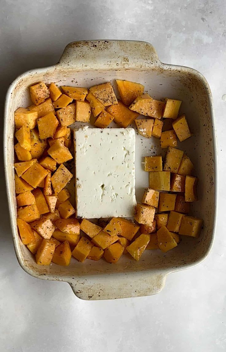 cubed sweet potatoes and butter in a baking dish