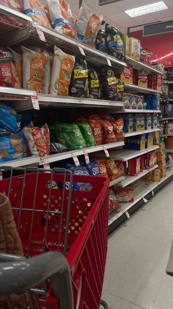 a grocery store aisle filled with lots of food and bags on the shelves next to each other