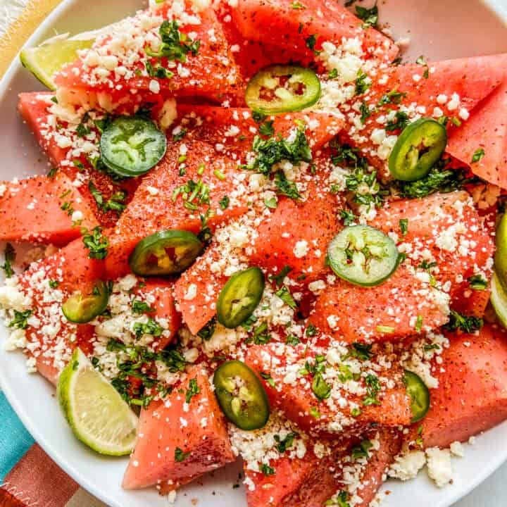 watermelon salad with feta cheese and jalapenos on a white plate