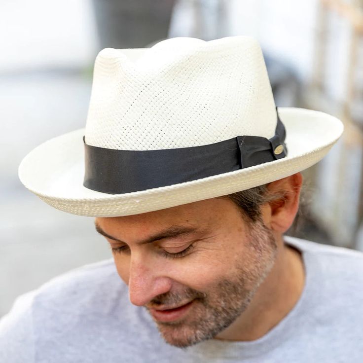 This bleached white panama fedora is a real looker. It has a teardrop crown and features wire in the brim for minor shape adjustments. Brim can be worn as shown in the picture or "snapped" up. It comes finished with a 16-Ligne grosgrain ribbon around the crown, a discrete bow and a removable Scala emblem. Additional information: Scala Panamas come with an "uncrushable" insert in the crown which prevents cracking from normal wear and tear. In addtion they come finished with a tefllon coating to repel mild water and oil based spills. Brim: 2 5/8" Crown: Front: 4" Side: 4 1/2" Upf Clothing, Outback Hat, Grade 3, Fedora Hat, Hat Sizes, The Crown, Grosgrain Ribbon, Sun Hats, Face Shapes