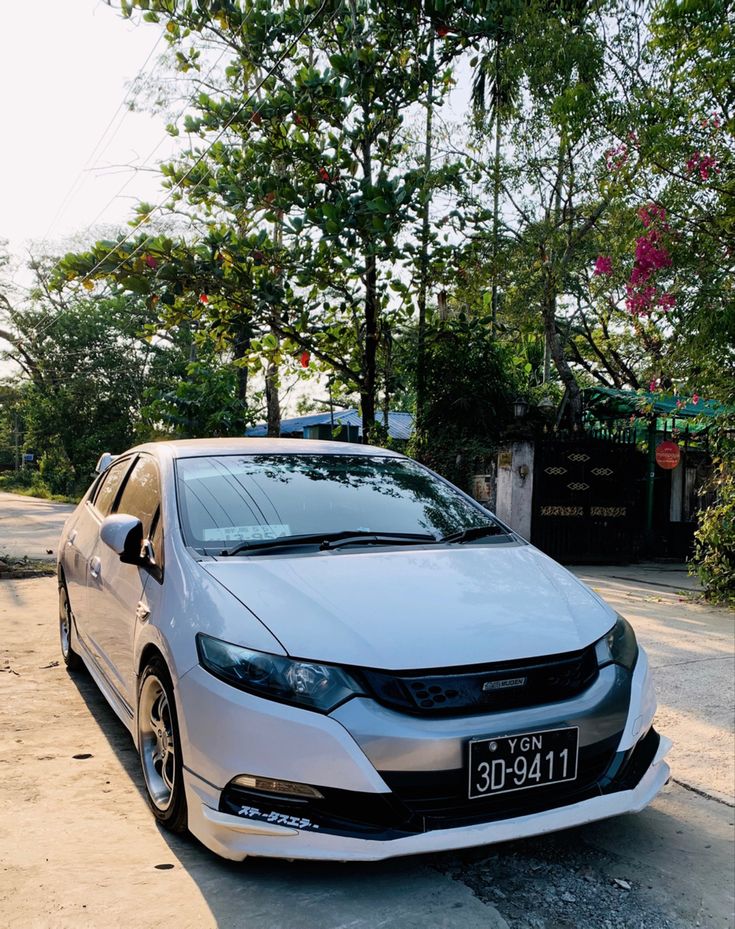 a white car parked on the side of a road