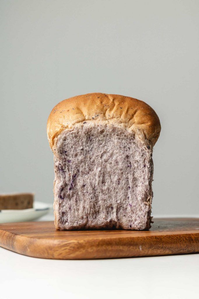 a loaf of bread sitting on top of a wooden cutting board