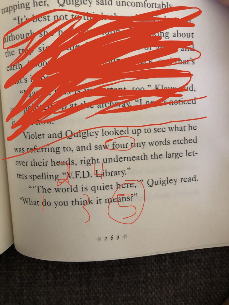 an open book with red writing on it