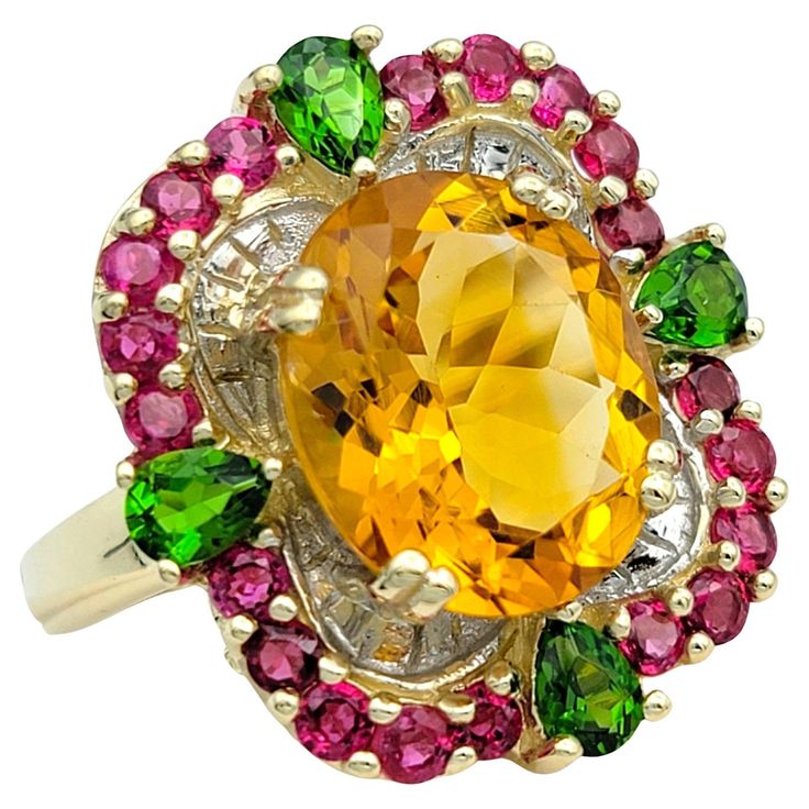 Ring Size: 6.5 This stunning ring showcases a vibrant blend of gemstones set in 14 karat yellow gold, creating a captivating and colorful design. At its center is a large oval citrine, radiating warmth and brilliance. Surrounding the citrine is a halo of round rubies, adding a rich contrast of color and depth to the piece. Accentuating the design are pear-shaped peridot stones, which enhance the ring's overall aesthetic with their fresh green hue. The combination of citrine, rubies, and peridot creates a dynamic and eye-catching composition, making this ring a unique and stylish accessory for any occasion. With its bright colors and elegant design, it's sure to be a standout addition to any fine jewelry collection. This piece is in very good estate condition and has been professionally cle Glamour Jewelry, Red Topaz, Peridot Color, Ring Ruby, Citrine Jewelry, Gift Suggestions, Sterling Silver Bangle Bracelets, Gold Gemstone Ring, Solid Gold Ring