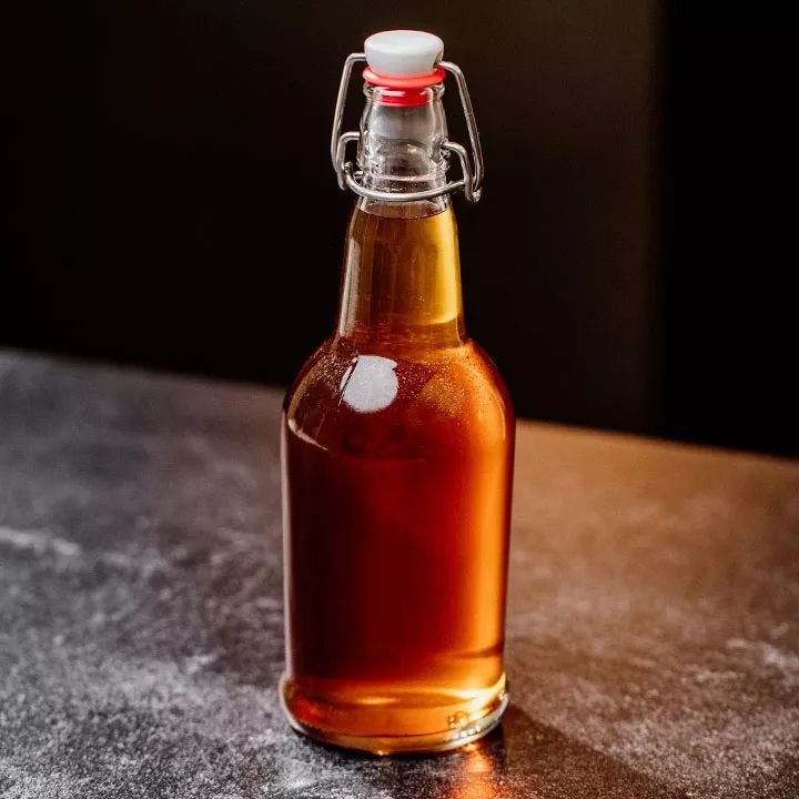 a glass bottle filled with liquid sitting on top of a table