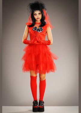 a doll dressed in red with black hair