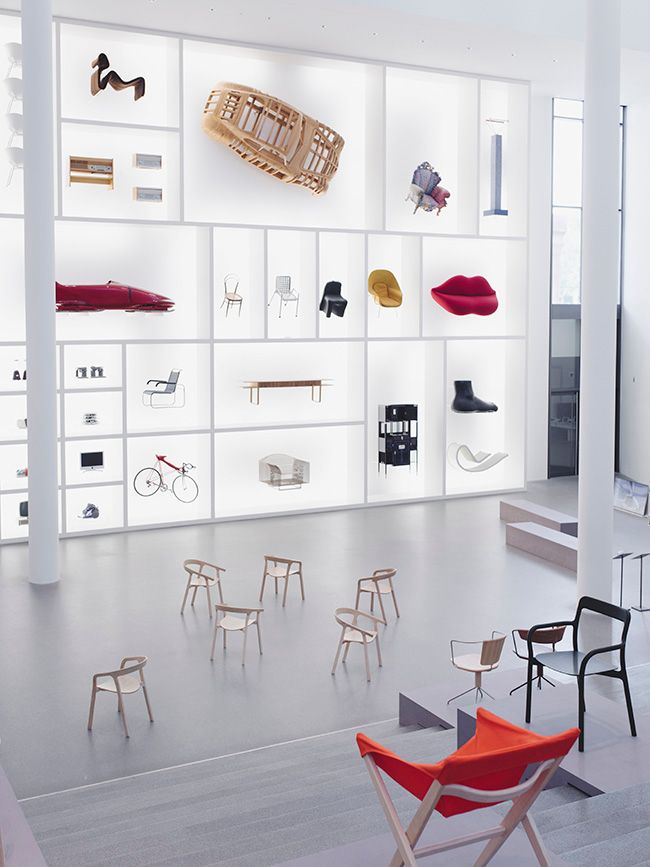 a room filled with lots of different types of furniture and accessories on display in white shelving