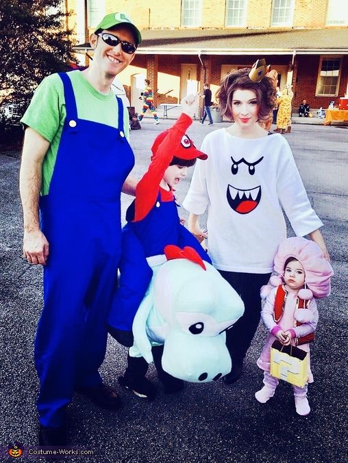 a man, woman and child are dressed up as characters from the movie toy story book