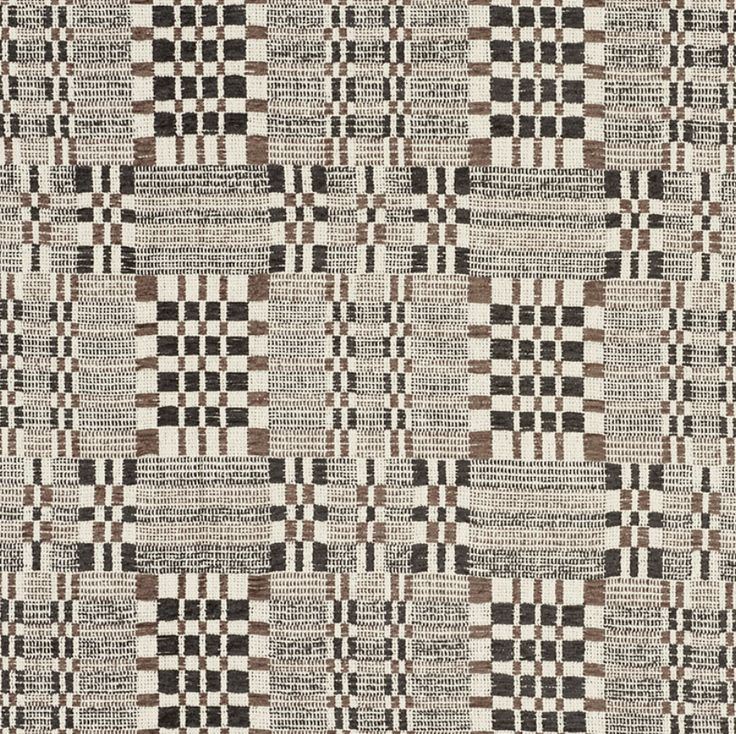 a black and white checkered rug with brown squares on it's sides,