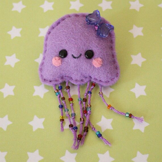 a purple jelly with beads and a bow on its head