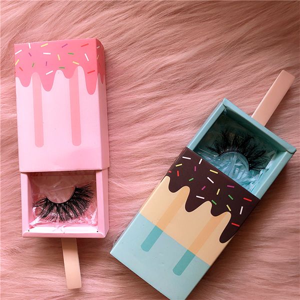 an open box with a fake eyelashes in it next to a fake ice cream cone