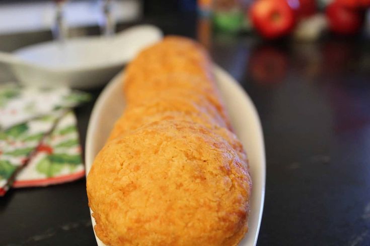 a close up of a doughnut on a plate with other food items in the background