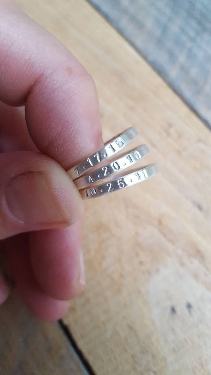 "These stacking name rings are hand stamped with the name of your choice. I form these rings from thick wire in the metal of your choice (sterling silver or 14K gold) and then hammer them to size. It leaves them with a subtle hammered finish. I then hand stamp the names onto the rings. They are skinny yet thicker than some of my other name rings and are about 2mm wide. In the photos, the rings have a matte finish, but they can also have a shiny or brushed finish. I wear a stack of these around m Personalized Silver Ring With Meaningful Style, Adjustable Stackable Rings With Custom Name For Anniversary, Custom Name Adjustable Stackable Rings For Anniversary, Customizable Adjustable Sterling Silver Engraved Ring, Adjustable Customizable Engraved Sterling Silver Ring, Anniversary Stackable Rings With Names In Sterling Silver, Anniversary Sterling Silver Stackable Name Rings, Adjustable Personalized Silver Stackable Rings, Anniversary Sterling Silver Stackable Rings With Names