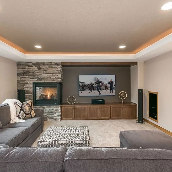 a living room filled with furniture and a flat screen tv mounted to the side of a wall