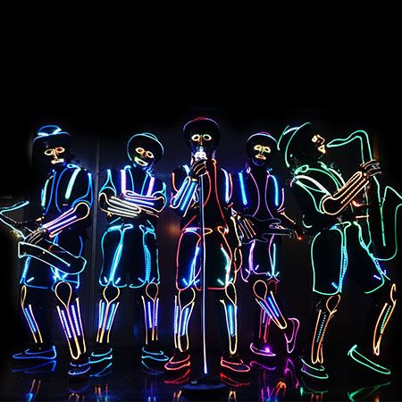 an image of neon people standing in the dark with their arms around each other's shoulders