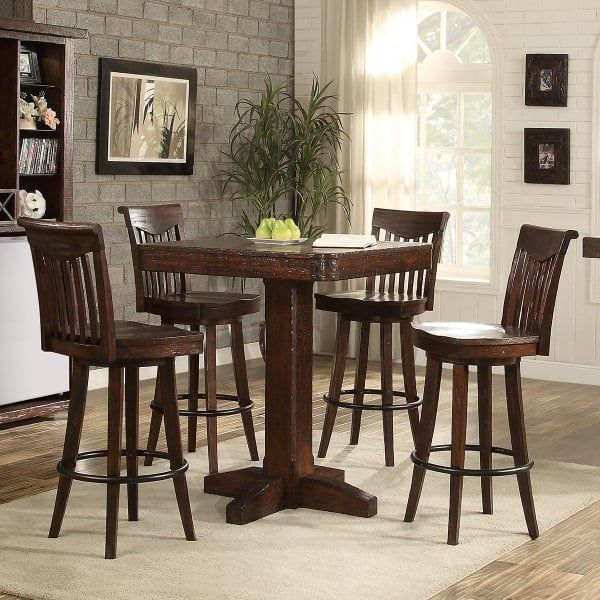 a kitchen table with four chairs around it