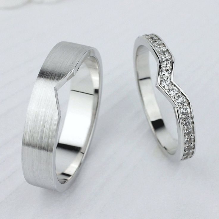 two white gold wedding rings with diamonds on each one and the other in different sizes