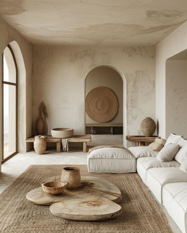 a living room filled with lots of furniture and large windows in front of the wall