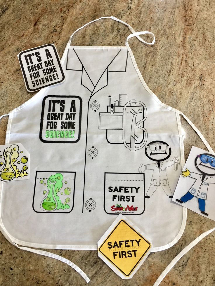 a white apron with stickers on it sitting on top of a counter next to a sign