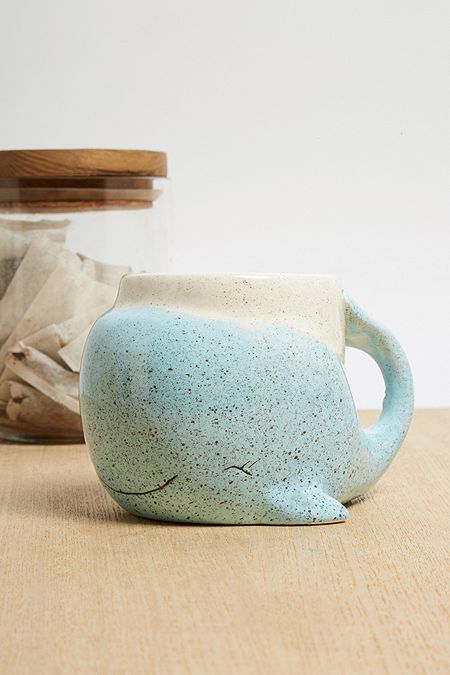 a ceramic mug sitting on top of a wooden table