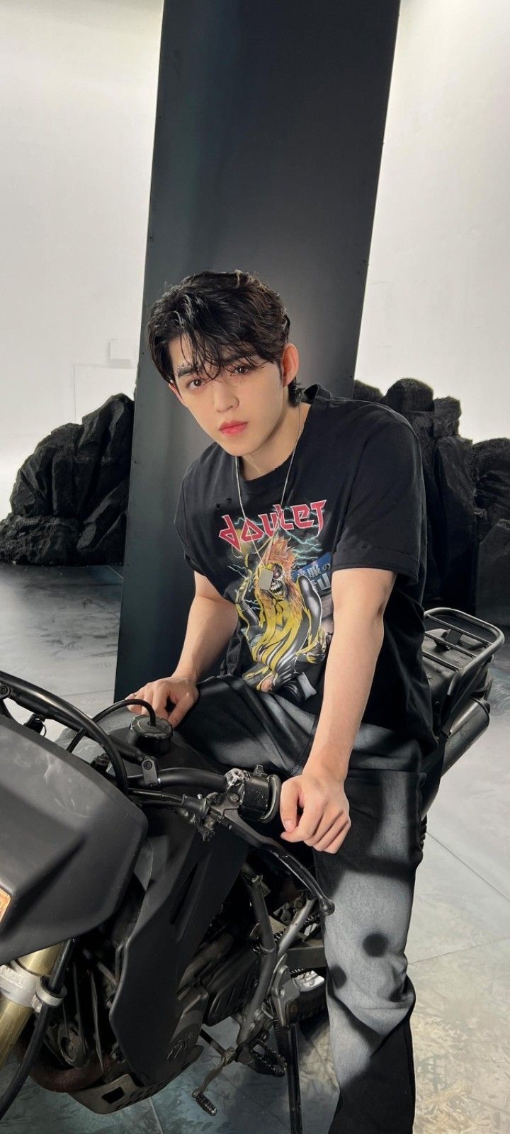 a young man sitting on top of a motorcycle