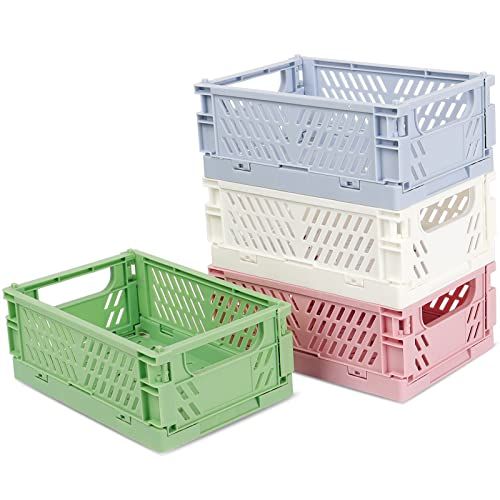 three different colored plastic crates sitting next to each other