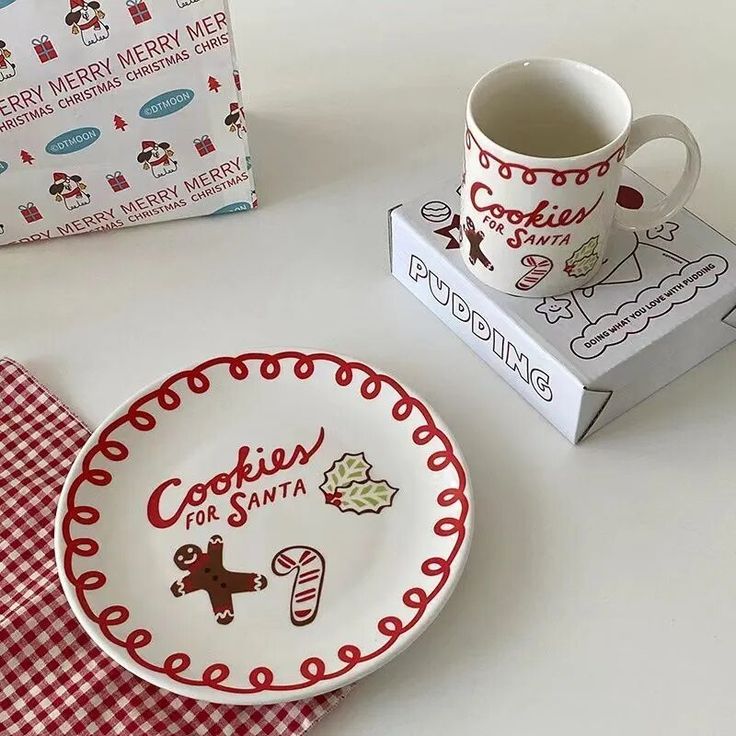 a couple of plates and cups sitting on top of a white table next to a box