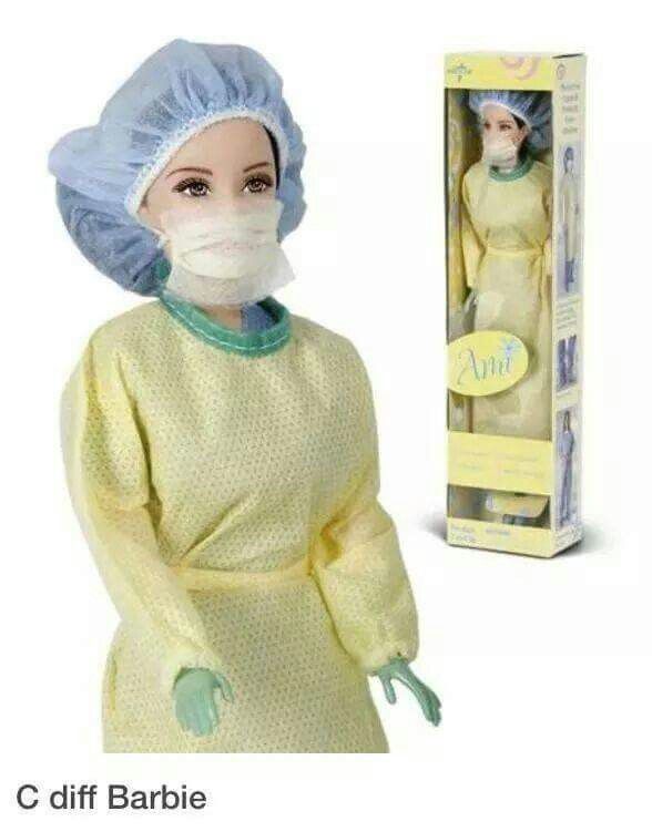 the doll is wearing a surgical mask and gown