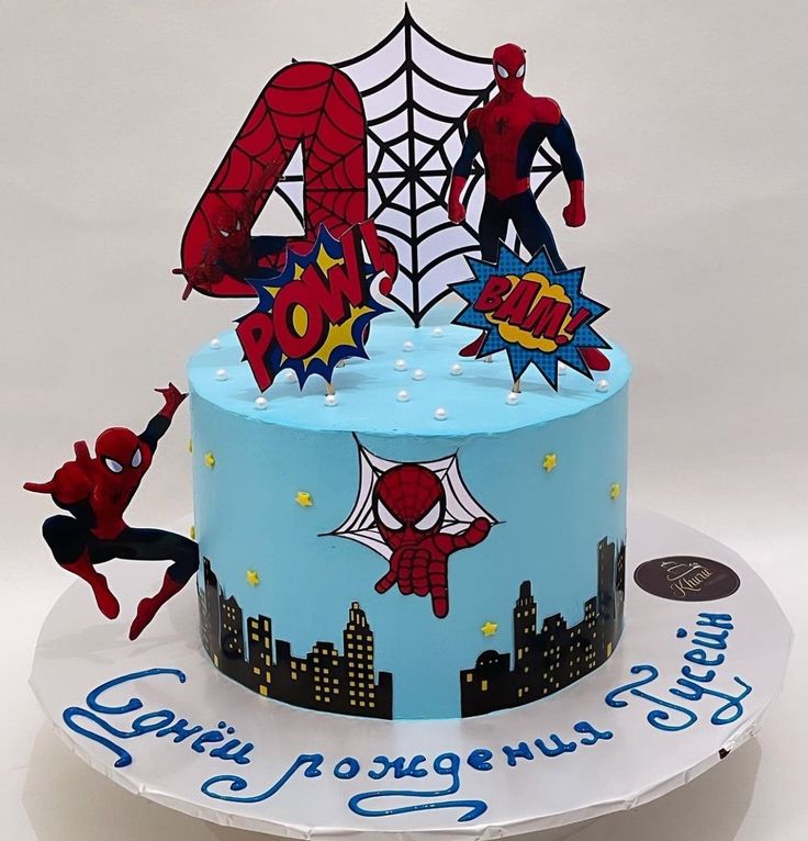 a birthday cake with spiderman decorations on it