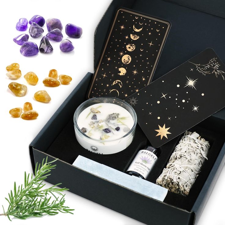 an open box containing various items including soaps, crystals and other decorative items on a white surface