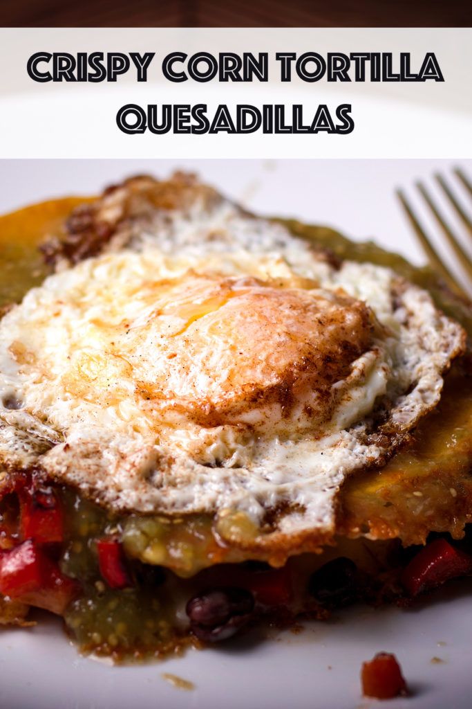 a close up of food on a plate with a fork and text that reads crispy corn tortilla quesadillas